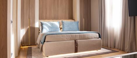 A modern bedroom with a bed, a glass partition, and a view of the outside.