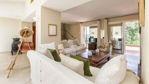 A spacious living room with a white sofa, a wooden coffee table, and a staircase leading to an upper level. - Pool, Villa La Colline, beautiful view of Mt Ventoux (Suzette)