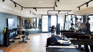 A gym with treadmills, weight machines, and free weights.