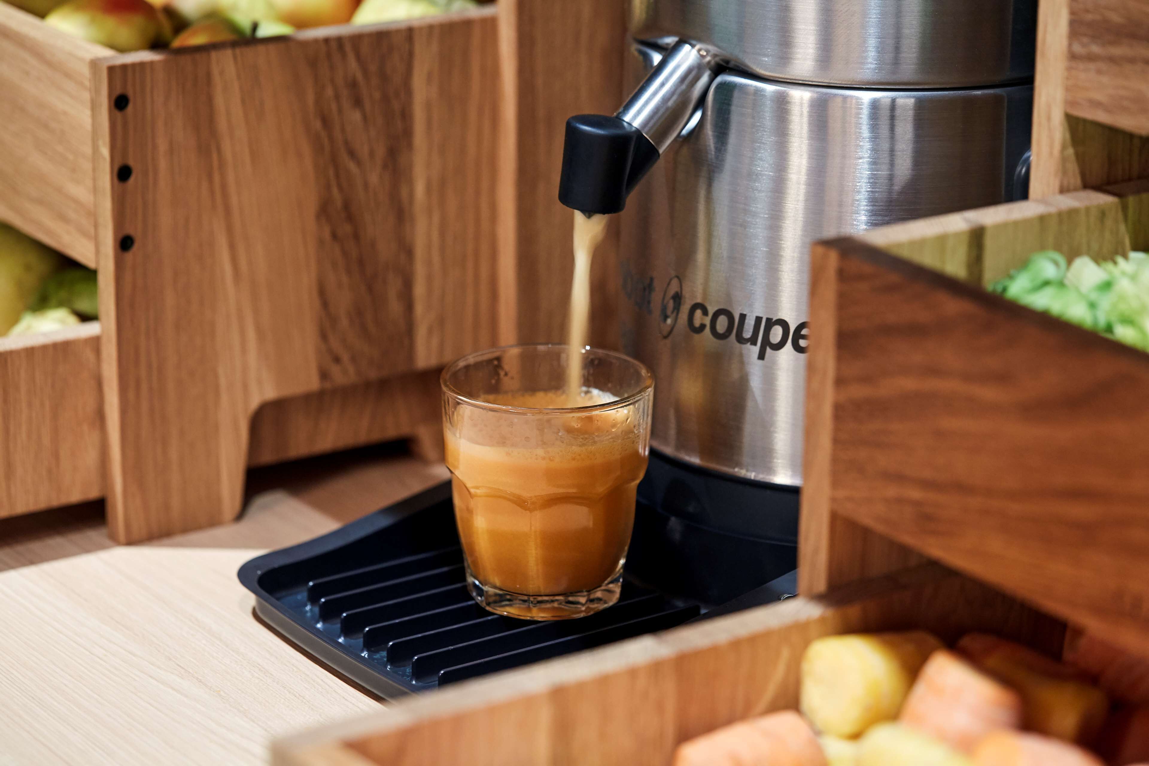 A coffee machine dispensing coffee into a glass.