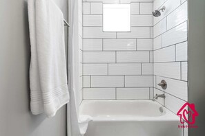 Bathtub, hair dryer, towels, soap