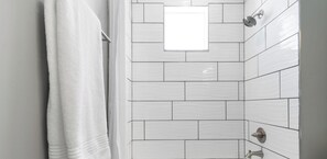 Bathtub, hair dryer, towels, soap
