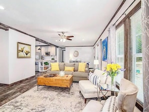 Relax in this inviting living space with a sofa, armchair, and coffee table.