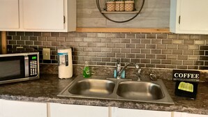 A kitchen with a microwave, coffee maker, and a sink. - Studio B on Main St in Helen - Walkable to restaurants and attractions (Helen)