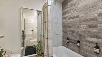 Combined shower/bathtub, hair dryer, towels, soap