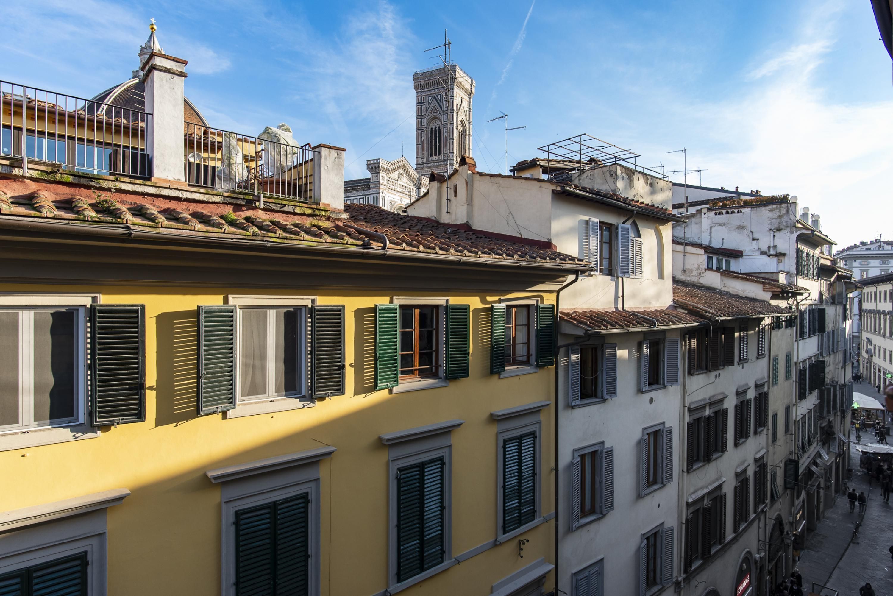 A row of buildings with multiple windows and balconies, typical of a European cityscape.