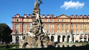 A large building with a classical architectural style, featuring multiple windows and a central entrance. - Apartment (Torino)