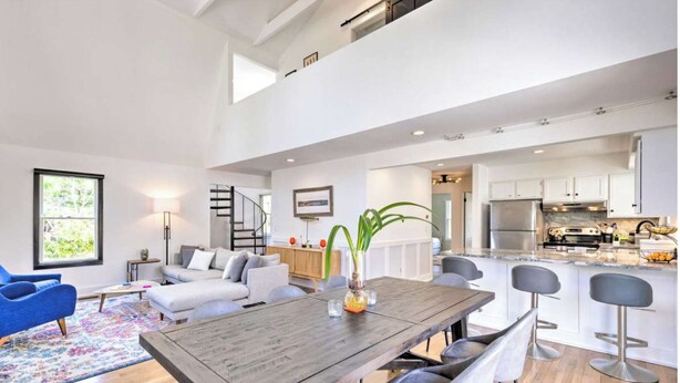 A spacious living area with a dining table, sofas, and a kitchen in the background. - Upscale Hamptons Home: 1 Mi to Sammys Beach! (East Hampton)
