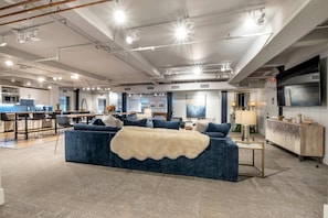 Relax in a stylish living area with a plush sofa, dining space, and bar counter.