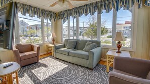 A living room with a sofa, armchairs, a coffee table, and a patterned rug. - Majestic Hotel & Apartments (Ocean City)