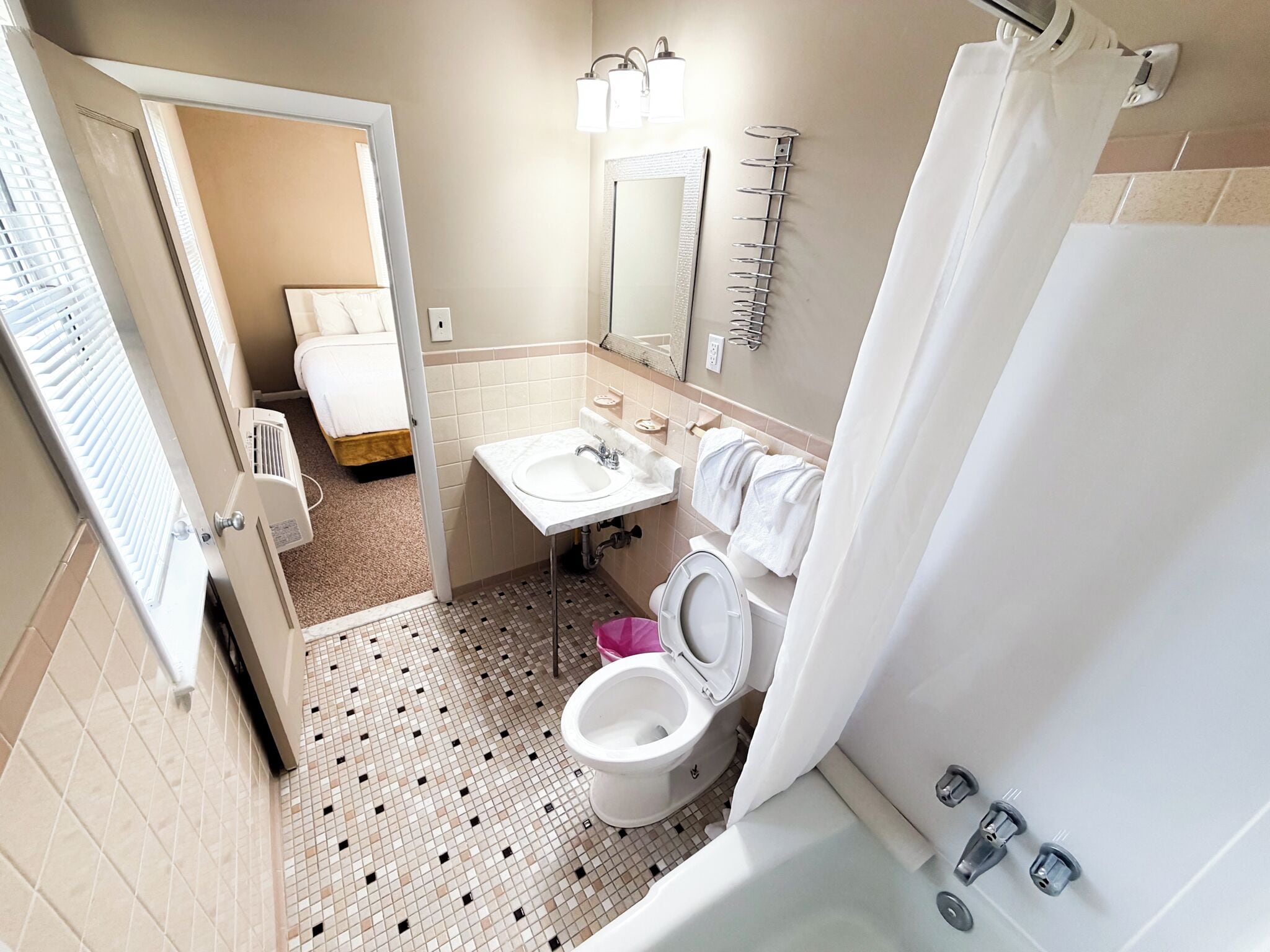 A bathroom with a toilet, sink, and bathtub.