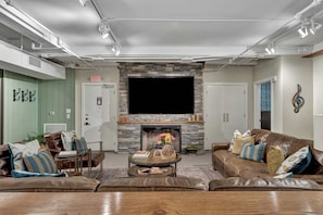 Relax in this cozy living space with a fireplace, flat-screen TV, and comfortable seating area.