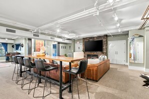 A modern home interior with a dining area, kitchen, and living space.