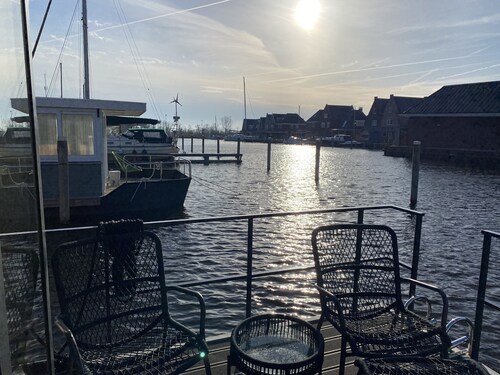 Luxury Houseboat with swim platform in colorful harbor