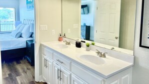 A bathroom with two sinks, a large mirror, and a window. - Stylish New Lake Condo with180° Lakefront View- Main Channel, Central Location! (Hot Springs)