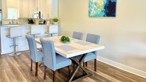 A modern kitchen with white cabinets, a coffee machine, and a sink. - Stylish New Lake Condo with180° Lakefront View- Main Channel, Central Location! (Hot Springs)
