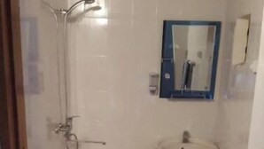 A bathroom with a toilet, a shower, and a sink. - Single Room with Private Bathroom (Buxoro)