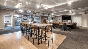 A spacious indoor area with a bar, seating arrangements, and a kitchen area. - Honky Tonk Suite/6 BR/3600sqft, Walkto Broadway (Nashville)
