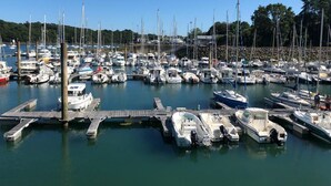 Un port de plaisance où de nombreux bateaux sont amarrés à des quais en bois.