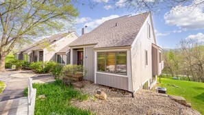 A row of single-story houses with a gravel driveway and a well-maintained lawn.