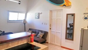 A compact living space with a kitchenette, a dining area, and a sofa. - Beachfront One Bedroom on Tamarindo Beach (Tamarindo)