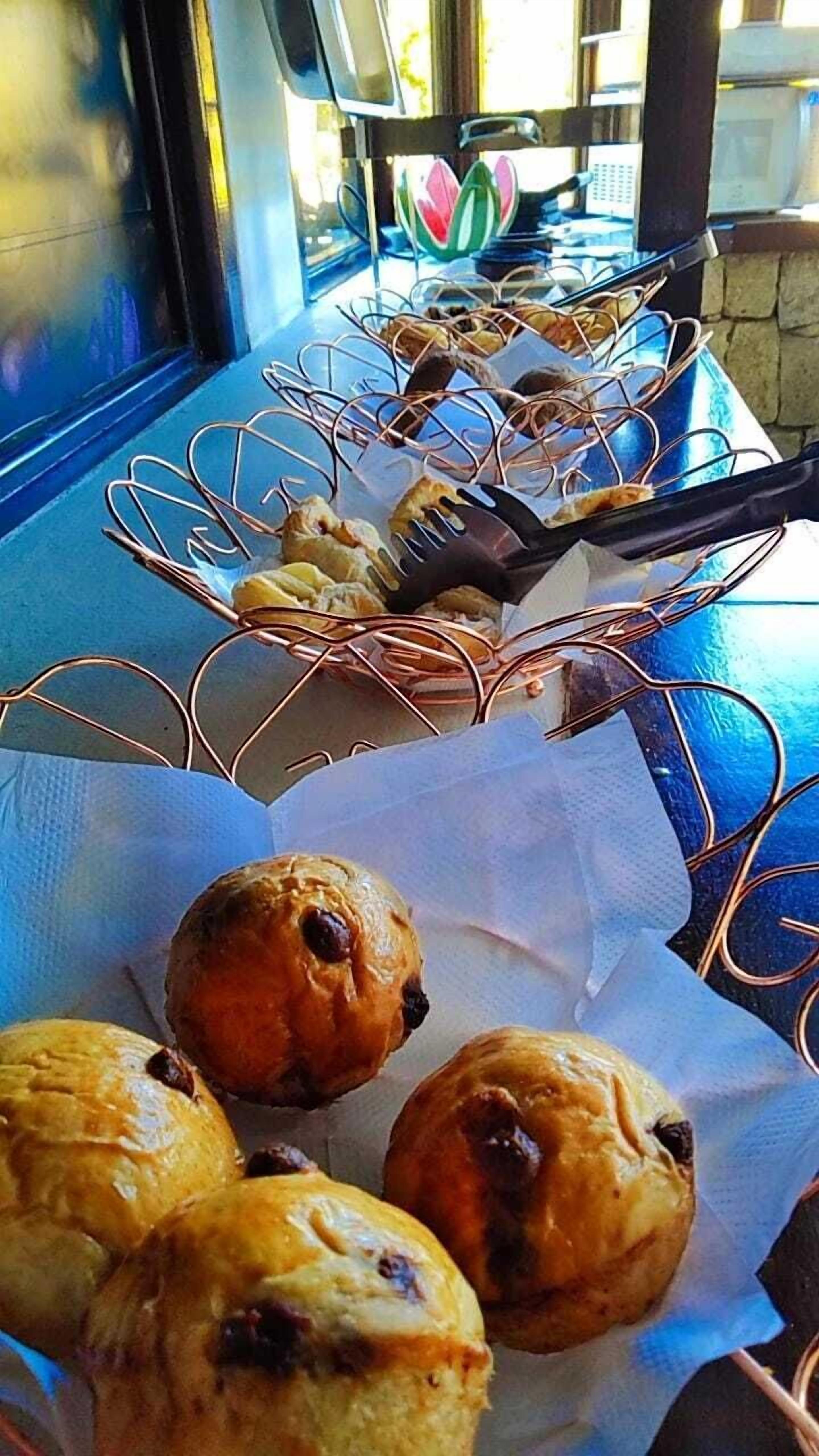 A table with pastries and a basket of items, possibly for sale.