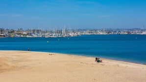A beach with a marina in the background. - On The Beach Clubhouse - Bayfront beauty (San Diego)