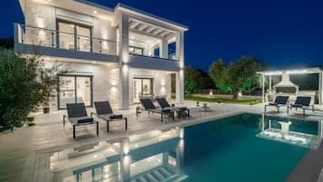 A heated pool, sun loungers