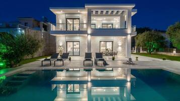 Relax in a spacious outdoor area with a swimming pool and enjoy the well-maintained garden and patio seating.