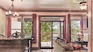 A spacious living area with a kitchen, dining table, and a sofa.