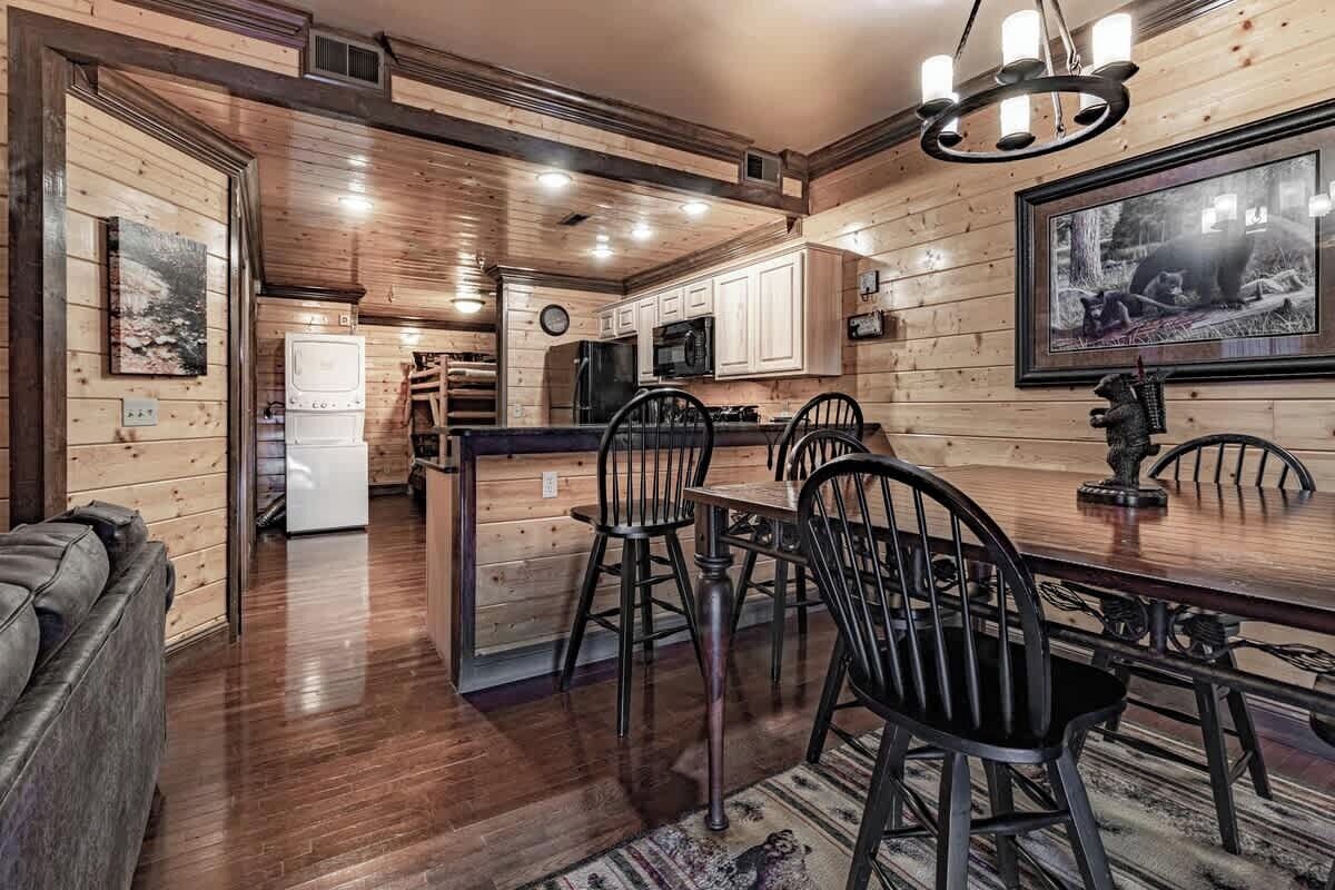 A wooden interior with a dining area, kitchen, and living space.