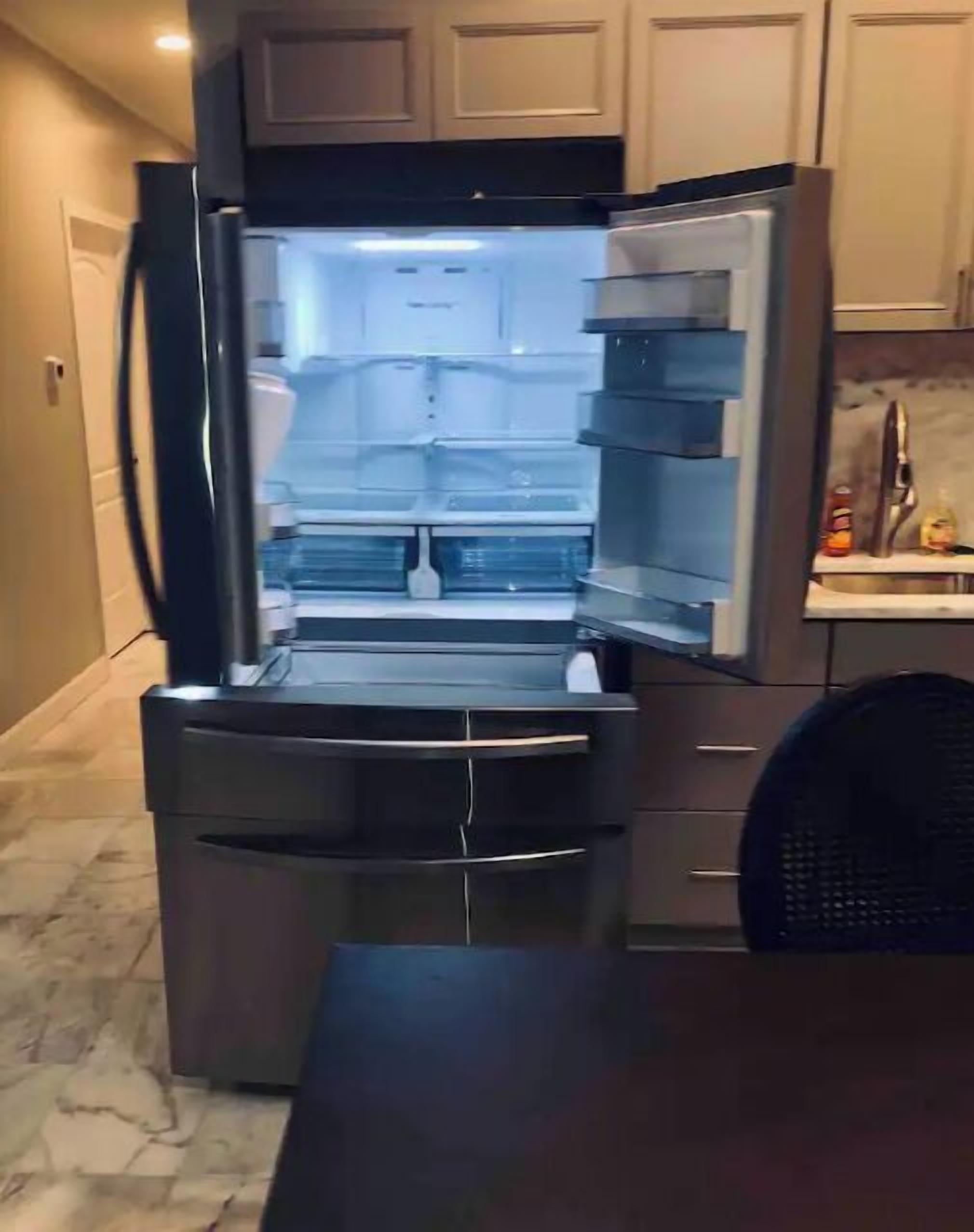 A compact kitchen with a built-in refrigerator, a sink, and a countertop.