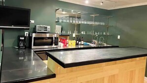A modern kitchen with a built-in microwave, toaster, and a glass shelf with wine bottles. - Spacious 4 bedroom- Great Location (Lexington)