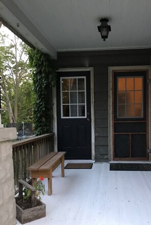 A porch with a bench, a door, and a window. - Minutes from anywhere (Moline)