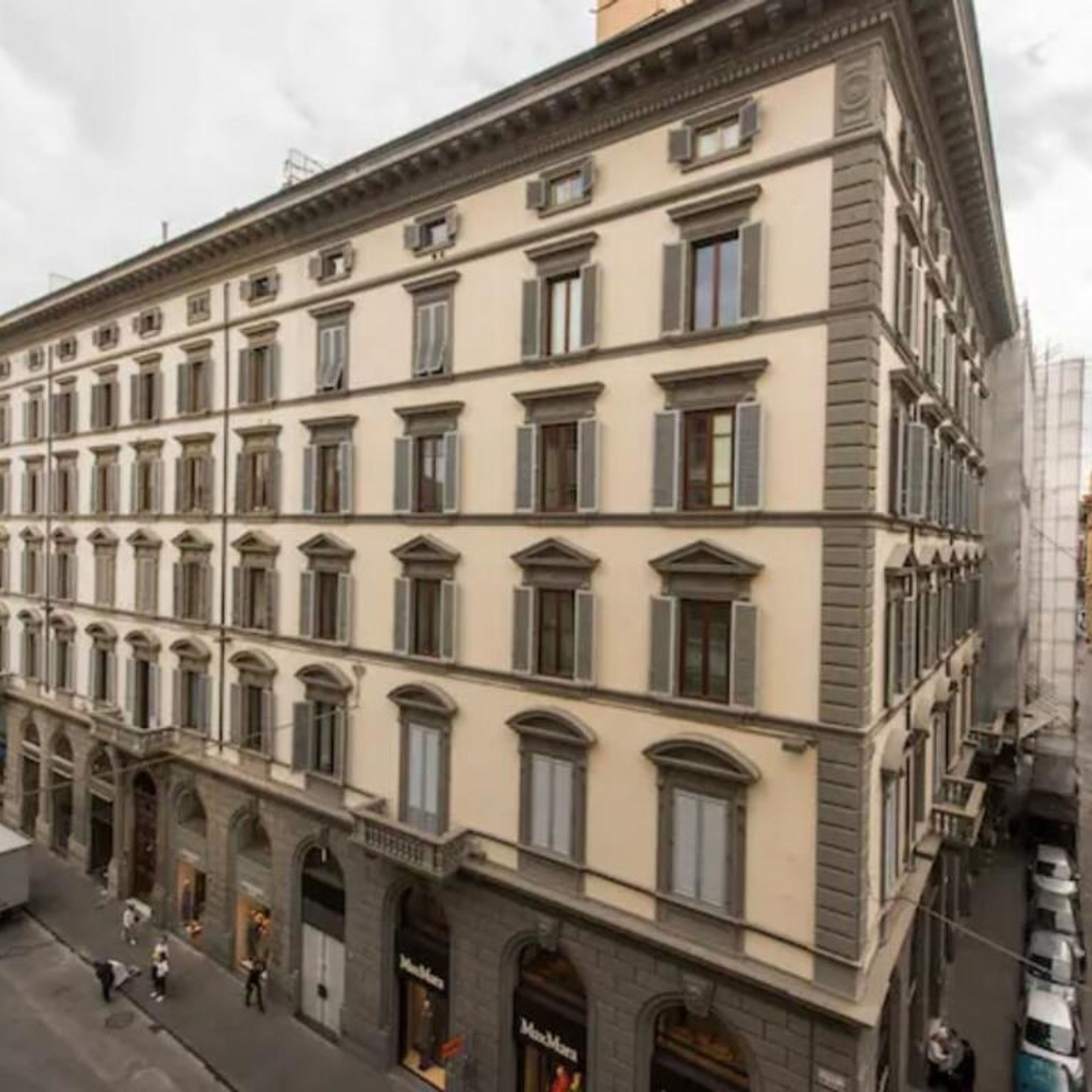 A multi-story building with a classical architectural style, featuring a symmetrical facade with evenly spaced windows and a central entrance.