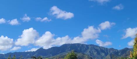 A mountainous landscape with clear skies and scattered clouds.