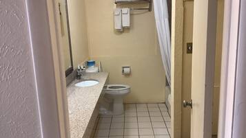 A small bathroom with a sink, toilet, and a towel rack.