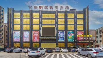 A multi-story building with large windows and several banners.