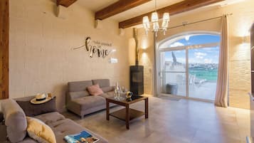 Family House, 4 Bedrooms (Inni Gozitan Farmhouse Private Pool) | Living area | 21-inch TV with cable channels, fireplace