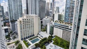 A high-rise urban area with modern buildings, a central courtyard with a pool, and surrounding greenery. - Lovely Brickell Oceanview Studio (Miami)