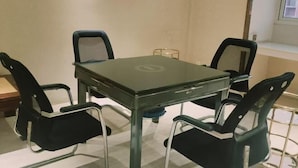 A conference room with a glass table, four black chairs, and a window. - Xuancheng Guangde Wanjia Express Inn (Guangde)