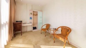 A room with a desk, two wicker chairs, a wardrobe, and a shoe rack. - Xuancheng Guangde Wanjia Express Inn (Guangde)
