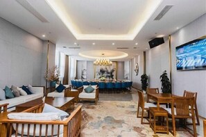 Guests can relax in the stylish lobby, surrounded by artwork and a large flat-screen TV.