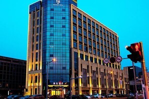 A modern hotel with a glass facade, multiple floors, and a prominent signage at the entrance. - Fragrans Hotel(Suzhou Lumu Metro Station Branch) (Suzhou)