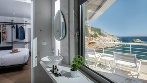 A modern bathroom with a large window, a white sink, and a potted plant. - Made By The Sea Villa 3 (Malevizi)