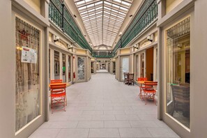 Relax in a spacious corridor lined with shops and seating areas.