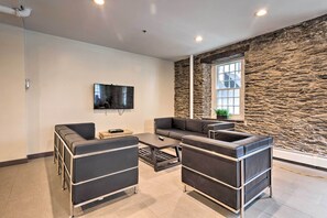 Relax in this stylish living room with a sectional sofa, coffee table, and flat-screen TV.