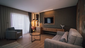 A modern living room with a sofa, armchair, and a small round table. - Panagia Premier Trabzon (Trabzon)