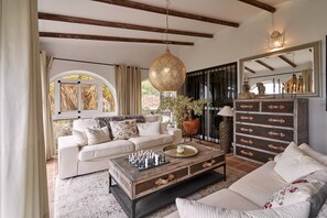 A living room with a sofa, coffee table, and a chessboard.