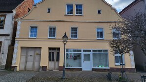 A building with a curved facade, multiple windows, and a door.